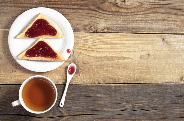 Tea and toasted bread with jam — Stock Photo, Image