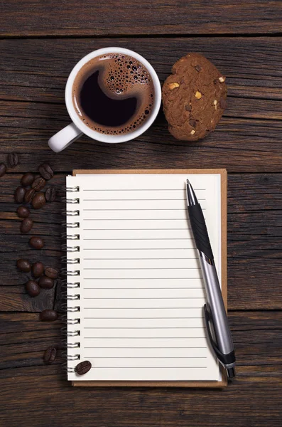Notebook, pen and coffee with cookie — Stock Photo, Image