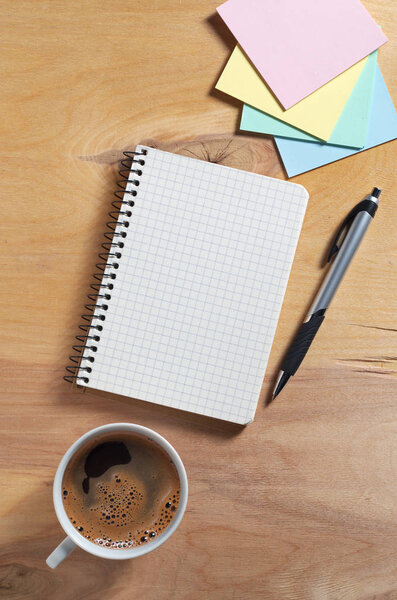 Notebook, sticky notes and coffee