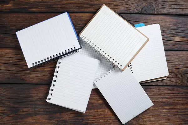 Various Opened Notebooks Heap Wooden Table Top View — Stock Photo, Image
