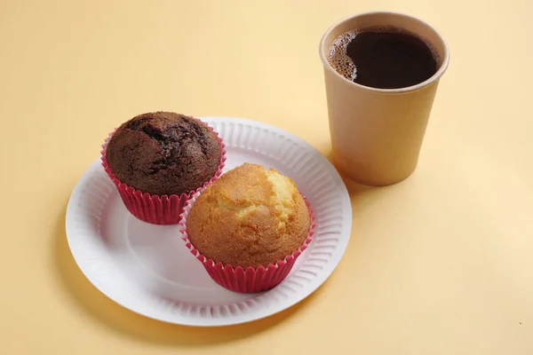 Muffins and cup of coffee. Takeaway food. Biodegradable dishes