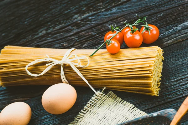 Pasta ingredients on wood — Stock Photo, Image