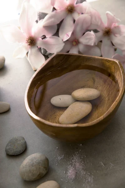 Spa and wellness. Natural massage stones , silkworm cocoon with magnolia flower .Spa treatment