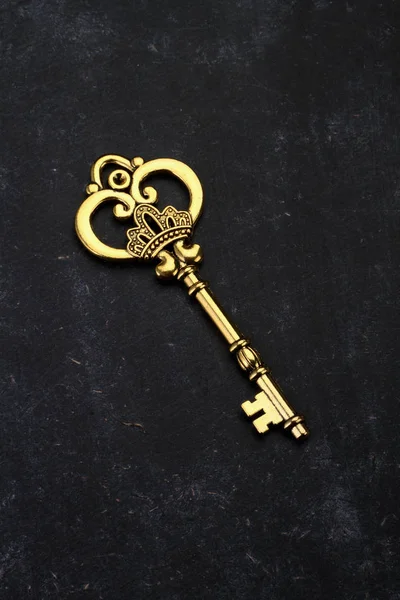 Golden Key with King's Crown on Black Background — Stock Photo, Image