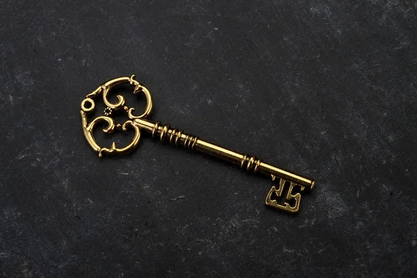 Golden Key on Black Grunge Background — Stock Photo, Image