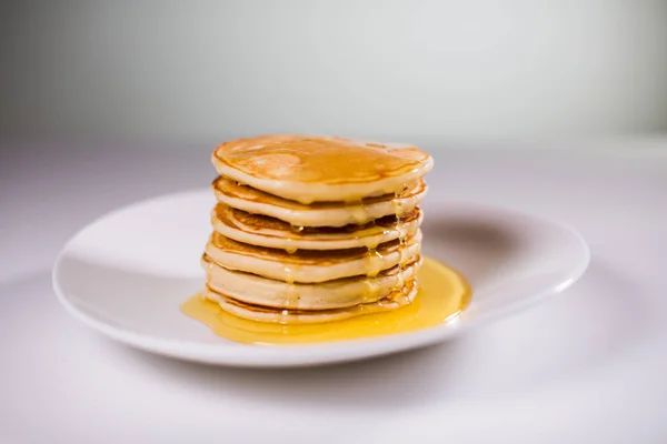 Stack of Small pancakes in syrup — Stock Photo, Image