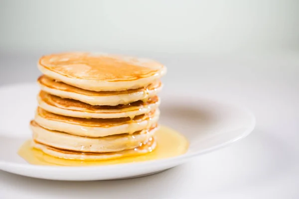 Stack of Small pancakes in syrup — Stock Photo, Image