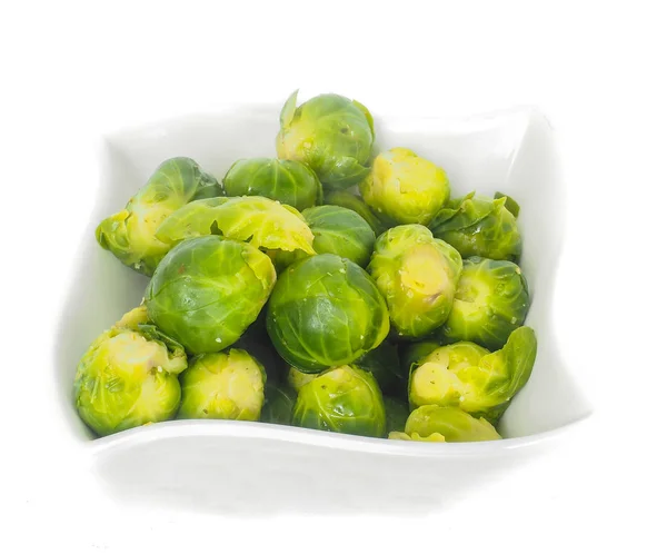 White designer bowl with fresh green brussels sprouts isolated on — Stock Photo, Image