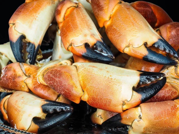 Pile of orange boiled with black tip, crab claws, at closeup — Stock Photo, Image