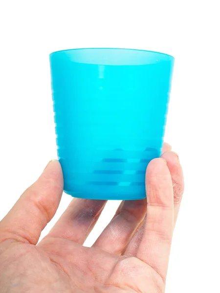 Empty blue plastic glass, held in a male persons hand — Stock Photo, Image