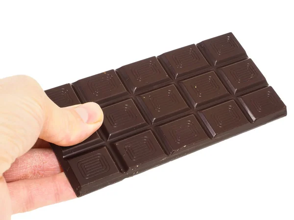 Pessoa segurando uma barra inteira de chocolate escuro isolado para wh — Fotografia de Stock