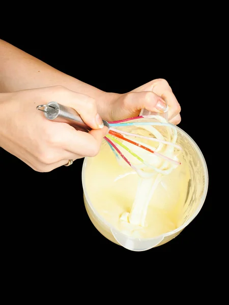 Female person making Gogl-Mogl, with hand whisker in plastic bow — Stock Photo, Image