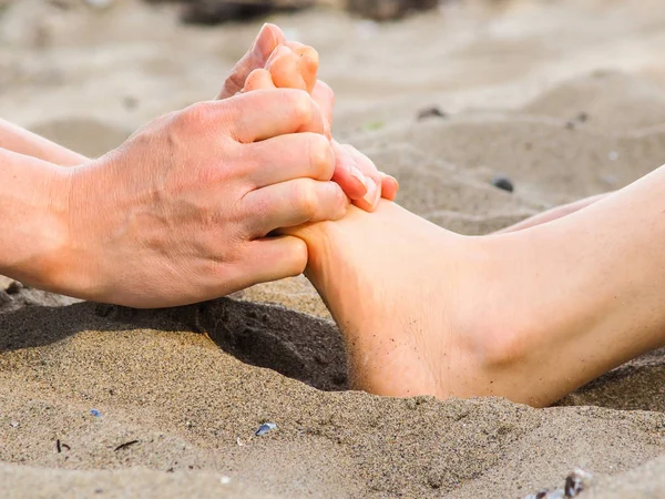 Foot massage on a beach in sand — Stock Photo, Image