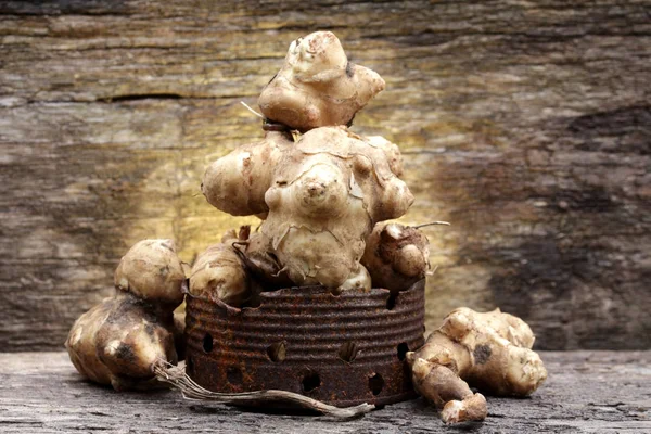 Jerusalem artichoke on wooden background — Stock Photo, Image