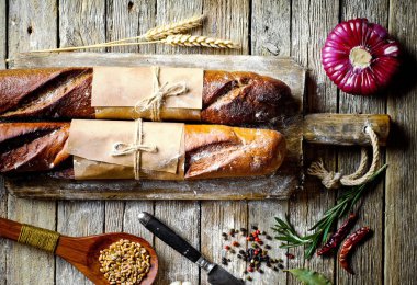 Ekmek ve hamur işleri eski bir arka plan üzerinde mutfak aksesuarları ile bir kompozisyon içinde