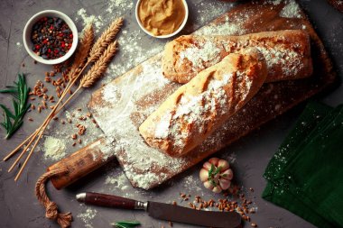 Ekmek ve hamur işleri eski bir arka plan üzerinde mutfak aksesuarları ile bir kompozisyon içinde