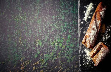 Ekmek ve hamur işleri eski bir arka plan üzerinde mutfak aksesuarları ile bir kompozisyon içinde