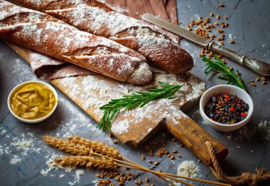 Ekmek ve hamur işleri eski bir arka plan üzerinde mutfak aksesuarları ile bir kompozisyon içinde