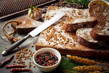 Ekmek ve hamur işleri eski bir arka plan üzerinde mutfak aksesuarları ile bir kompozisyon içinde