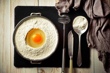 Mutfak aksesuarları ile bir kompozisyon içinde eski bir arka plan üzerinde un ile hamur