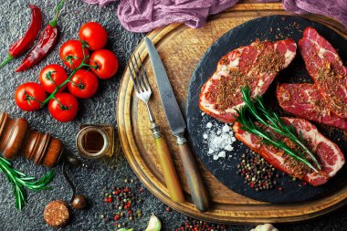 Mutfak masasında aksesuarları pişirme ile bir kompozisyon içinde metalik bir arka plan üzerinde çiğ et