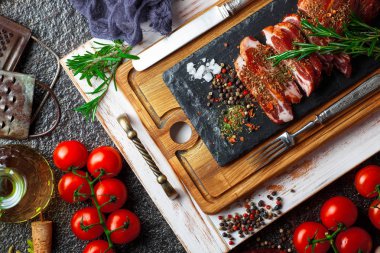 Mutfak masasında aksesuarları pişirme ile bir kompozisyon içinde metalik bir arka plan üzerinde çiğ et