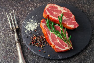 Mutfak masasında aksesuarları pişirme ile bir kompozisyon içinde metalik bir arka plan üzerinde çiğ et