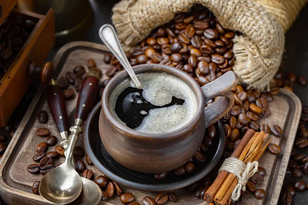 Coffee beans are roasted in a pan with smoke.