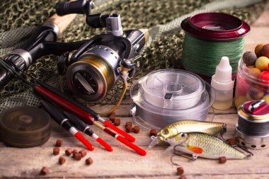 Balıkçılık çubuklar ve spinnings tablosundaki eski arka plan üzerinde balıkçılık için aksesuarlar ile kompozisyon