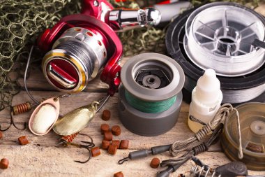 Balıkçılık çubuklar ve spinnings tablosundaki eski arka plan üzerinde balıkçılık için aksesuarlar ile kompozisyon