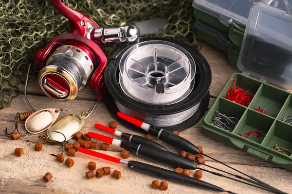Balıkçılık çubuklar ve spinnings tablosundaki eski arka plan üzerinde balıkçılık için aksesuarlar ile kompozisyon
