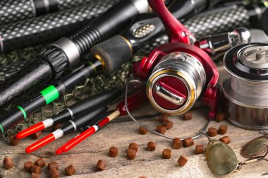 Balıkçılık çubuklar ve spinnings tablosundaki eski arka plan üzerinde balıkçılık için aksesuarlar ile kompozisyon