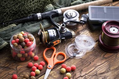 Tahta bir masada olta takımı..