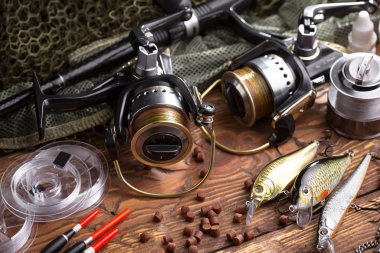 Balıkçılık çubuklar ve spinnings tablosundaki eski arka plan üzerinde balıkçılık için aksesuarlar ile kompozisyon