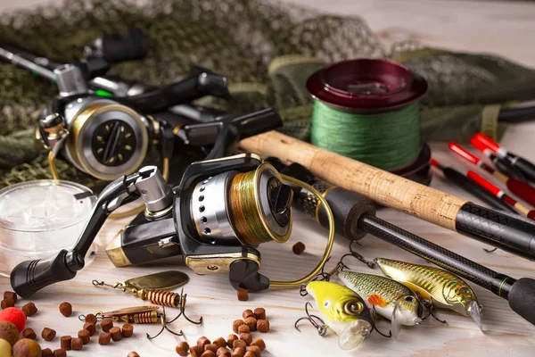 Balıkçılık çubuklar ve spinnings tablosundaki eski arka plan üzerinde balıkçılık için aksesuarlar ile kompozisyon