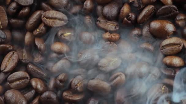 Roasted coffee beans with smoke in a pan