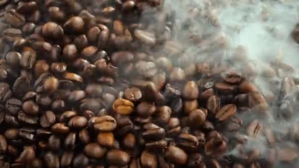 Roasted coffee beans with smoke in a pan