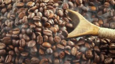 Kavrulmuş kahve çekirdekleri, tavada dumanla karıştırılır..