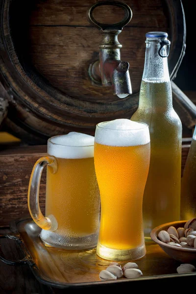 stock image Light beer in a glass on a table in composition with accessories on an old background