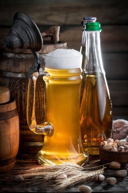 Masadaki bardakta hafif bira kompozisyonu ve eski bir arka planda aksesuar.