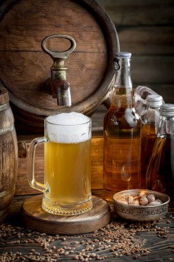 Masadaki bardakta hafif bira kompozisyonu ve eski bir arka planda aksesuar.