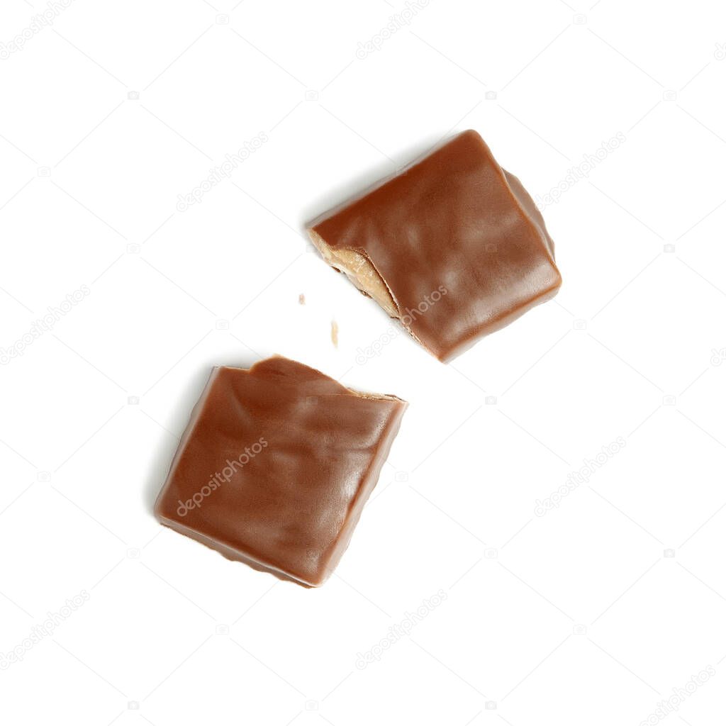 Chocolate bar broken into two halves with crumbs on white