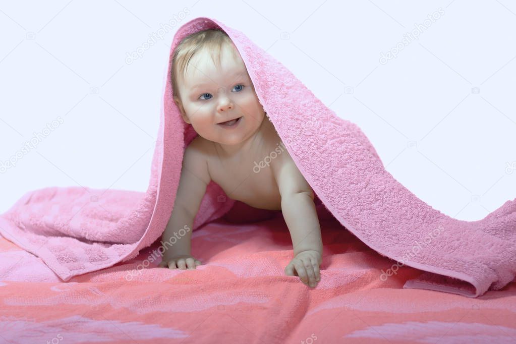 Little kid under pink towel