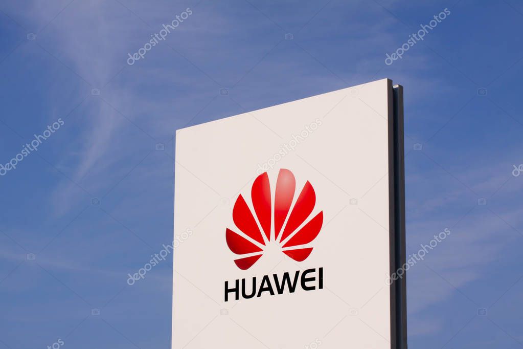 Huawei logotype on white panel sign by headquarters with clear blue sky. Chinese multinational company, is the largest telecommunications equipment maker in the world: Copenhagen, August 29, 2017