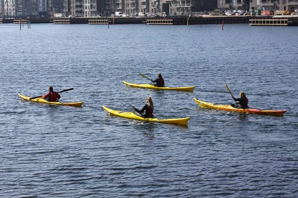 Group of kayaker paddling in kayak by the sea rowing, active water sport and leisure, kayaking