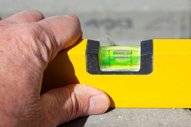 Close up of hand with spirit level clipart