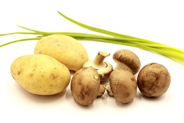 Vegetables: potatoes, mushrooms, green onions isolated on a white background