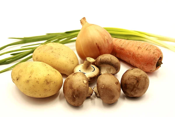 Vegetables: onions, carrots, potatoes, mushrooms, green onions. isolated on white background