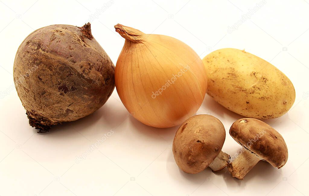 Vegetables: yellow onions, potatoes, beets and mushrooms isolated on white background