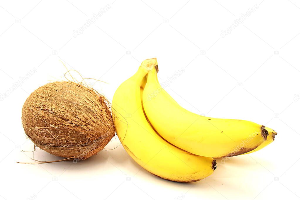 Coconut and ripe bananas close-up isolated on a white background